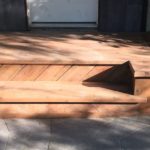 Old concrete step covered with pressure treated wood